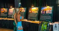 Guest viewing framed auction artwork at Paint the Town PINK