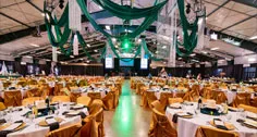 Green ceiling decorations above banquet tables at Paint the Town PINK
