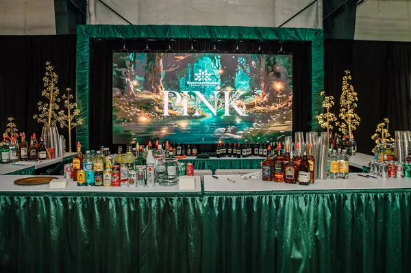 Forest-themed stage and auction display at Paint the Town PINK