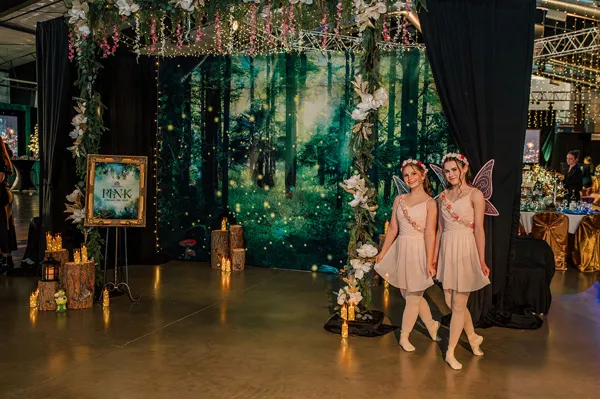 Guests entering the forest-themed event room at Paint the Town PINK