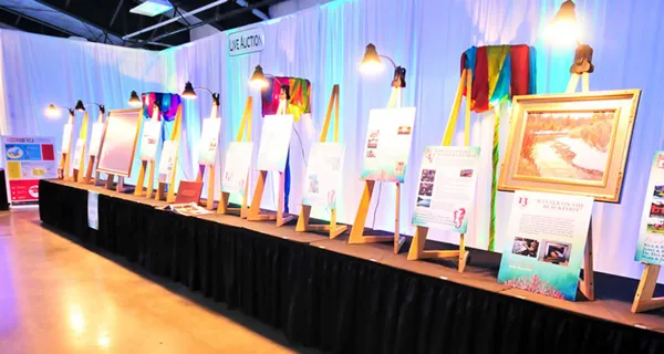 Auction items displayed along a table at Paint the Town PINK