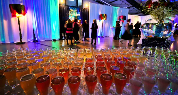 Rows of glasses prepared for the reception at Paint the Town PINK