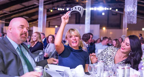 Guests raising their hands and cheering at Paint the Town PINK