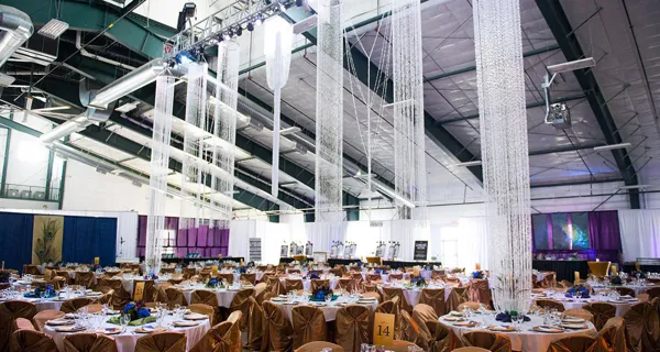 White ceiling drapes above banquet tables at Paint the Town PINK
