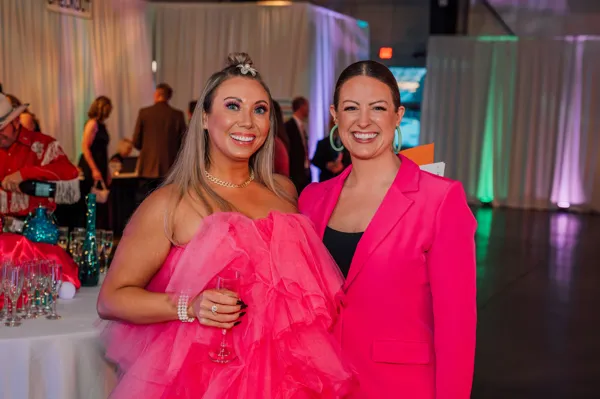 Two guests in pink dresses at Paint the Town PINK