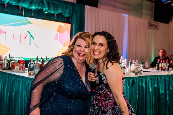Two guests smiling together at Paint the Town PINK