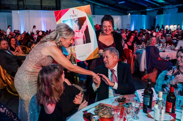 Guests gathered around a dinner table at Paint the Town PINK