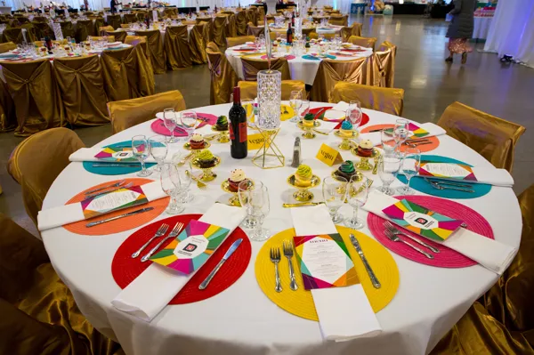 Colorful table setting with rainbow decorations at Paint the Town PINK